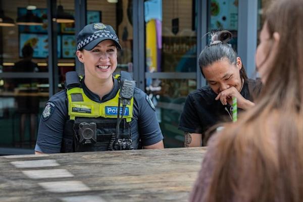 Photo of Victoria Police with laughing with two people