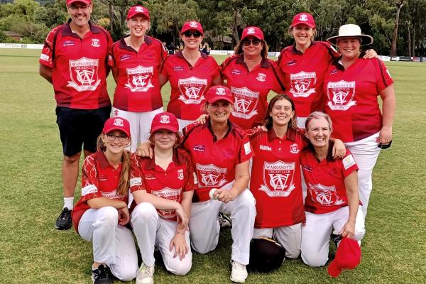 Group photo of Warrandyte womens cricket team all wearing red uniforms