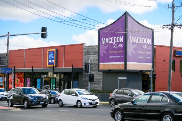 View of Macedon Square shops with purple signage and cars in the foreground