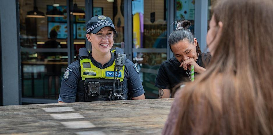 Photo of Victoria Police with laughing with two people