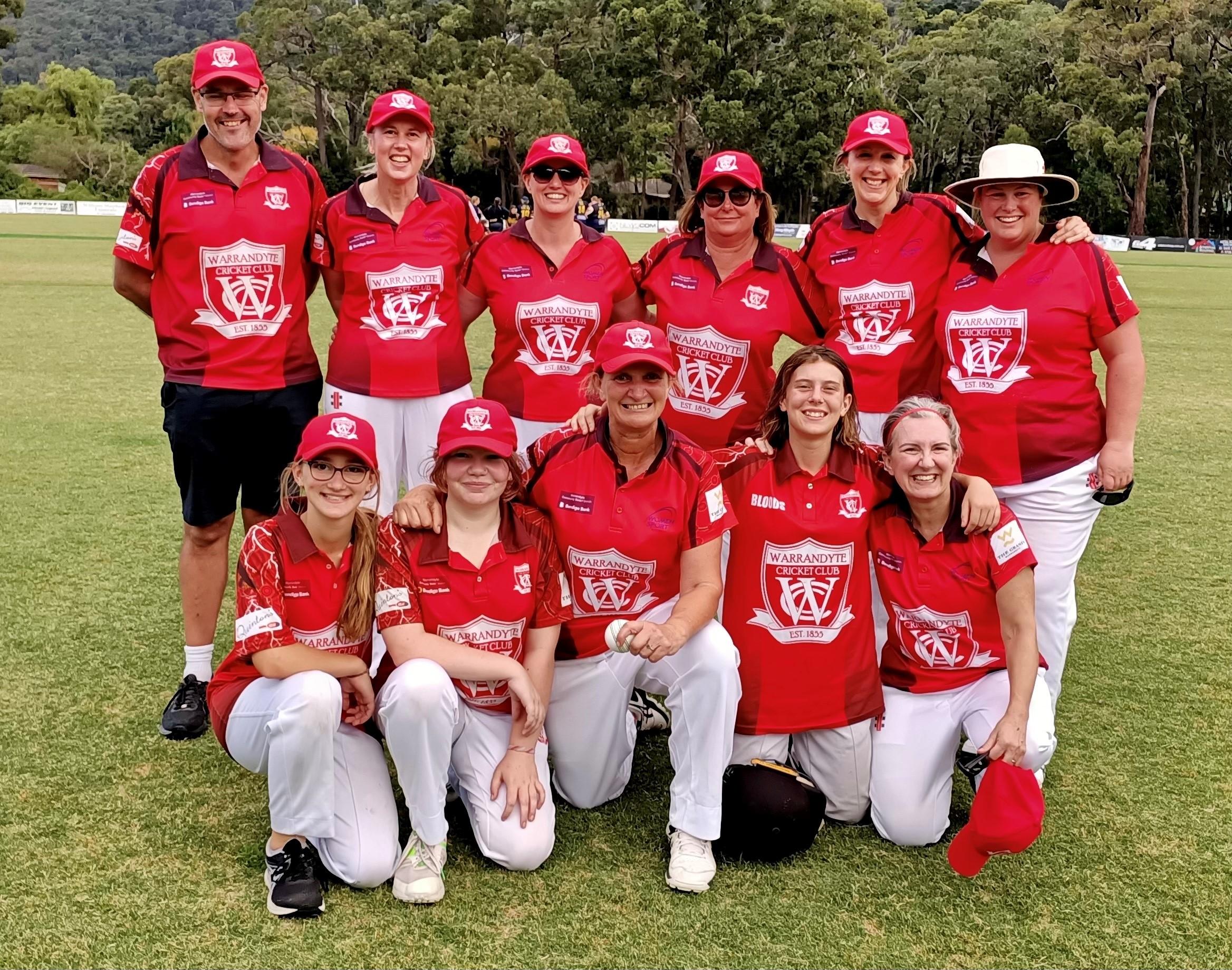 Group photo of Warrandyte womens cricket team all wearing red uniforms