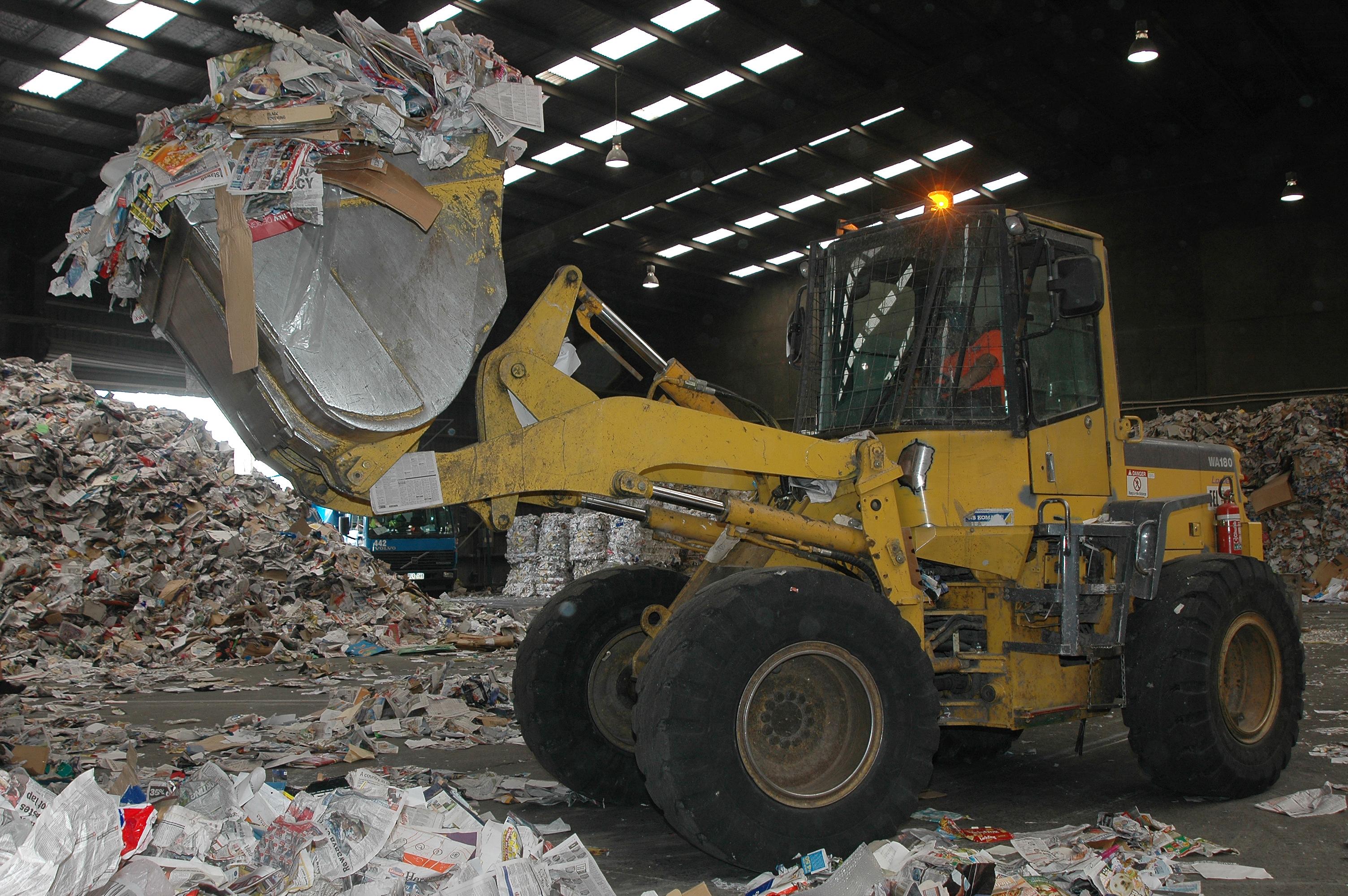 Photo of front loader sorting recyclables