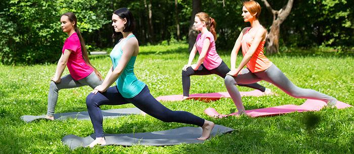 Women doing yoga in park