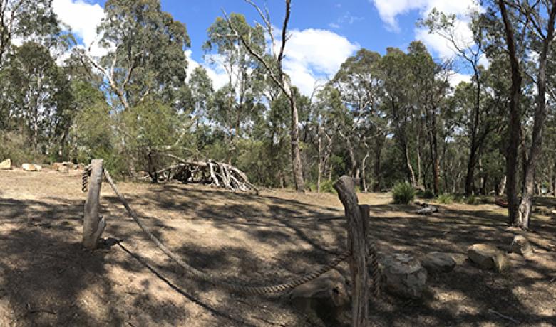 Panorama showing trees and children's play area with tent made of twigs