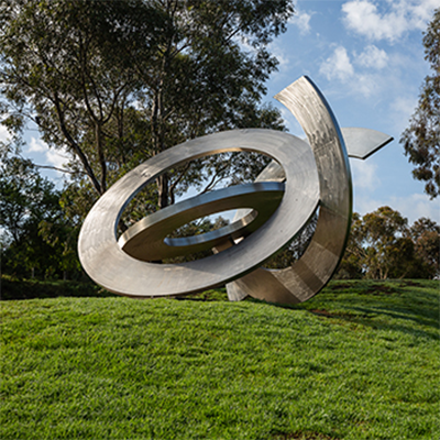 Art sculpture with swirling curves situated in park