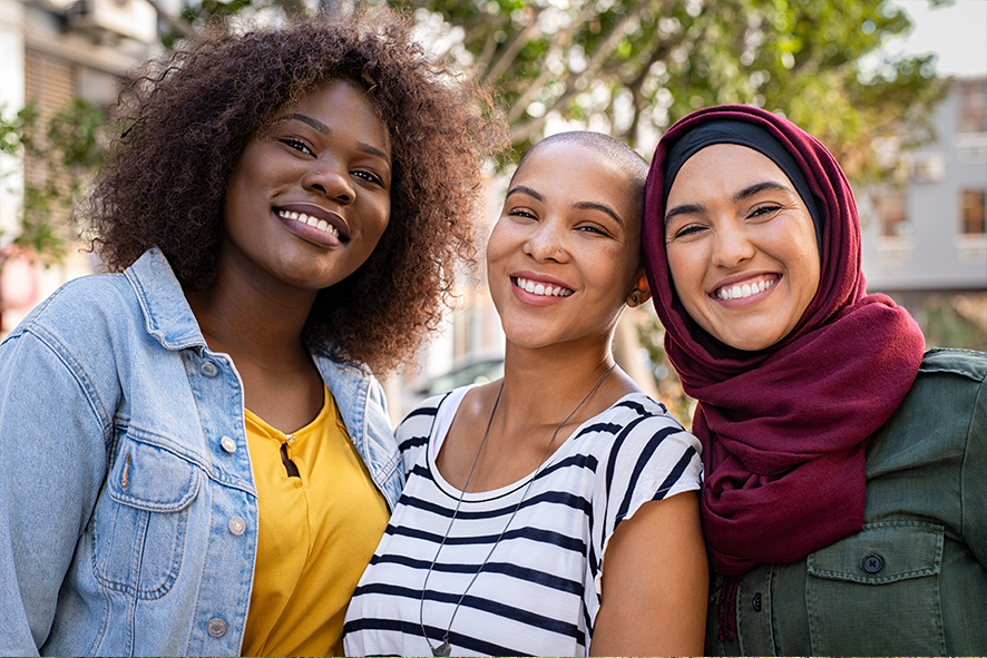 Three multi ethnic women smiling
